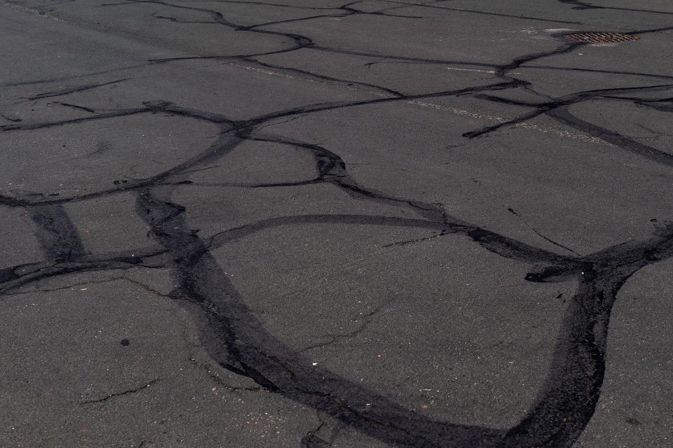 A patch of rough asphalt is pictured in the direct sun in Highlander Heights on Wednesday, July 10, 2024, in Fort Collins, Colo.