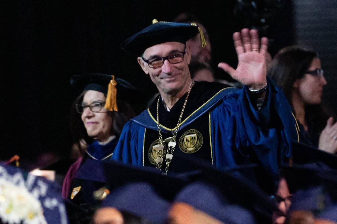 Florida International University President Kenneth Jessell waves as he walks in the commencement procession at the Modesto A. Maidique Campus in Miami on Tuesday, Dec. 13, 2022.