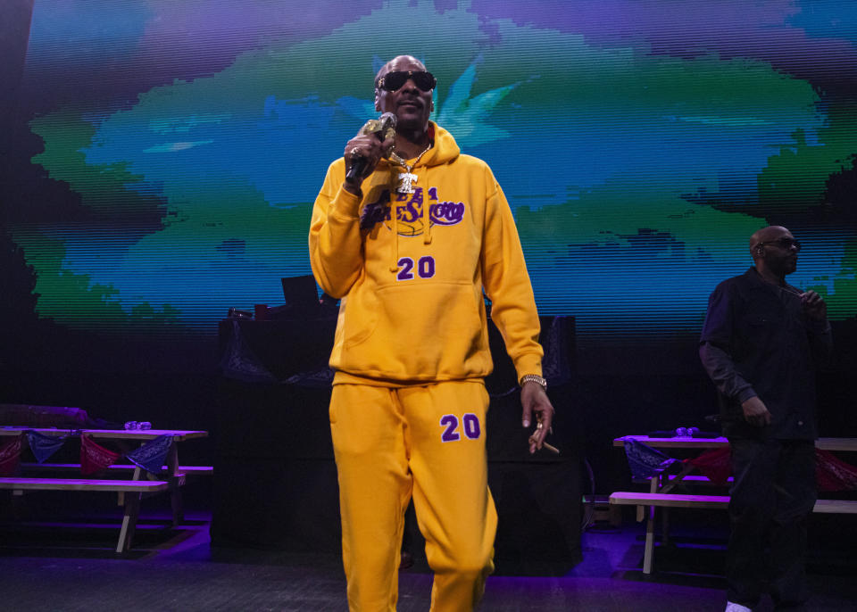 Snoop Dogg wears a Lakers sweatsuit during a performance in Detroit on Jan. 26.