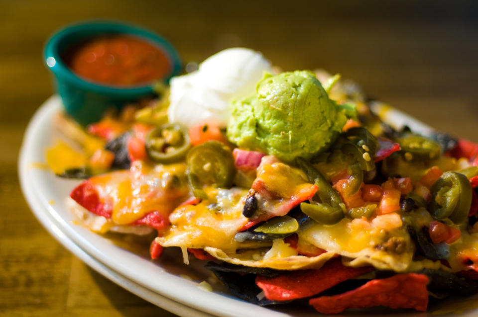 Don't even think about adding guacamole and sour cream before you put the chips in the oven. Those go on afterward. (Photo: 3dan3 via Getty Images)