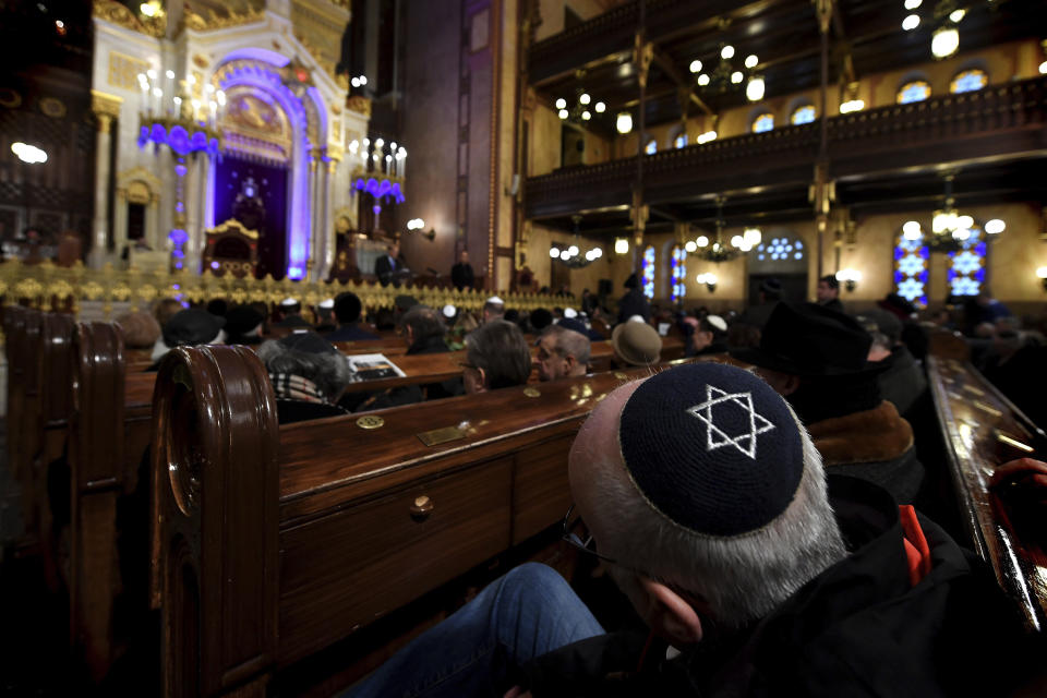 People attend a ceremony that commemorates the 75th anniversary of the liberation of the Budapest Jewish ghetto in Dohany Street Synagogue in Budapest, Hungary, Sunday, Jan. 19, 2020. The ghetto was liberated by the Soviet Red Army during World War II on January 17, 1945. (Tibor Illyes/MTI via AP)