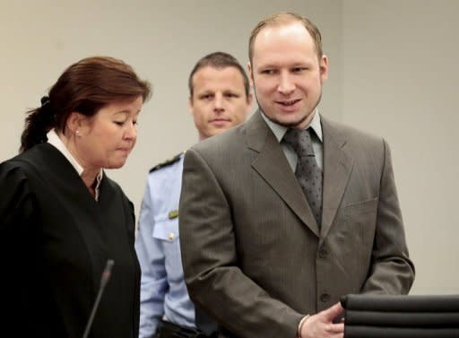 Norwegian killer Anders Behring Breivik arrives in court in Oslo with his lawyer Vibeke Hein Baera on April 25. A brother of one of Breivik's victims threw a shoe at him Friday, which missed the defendent but hit Hein Baera