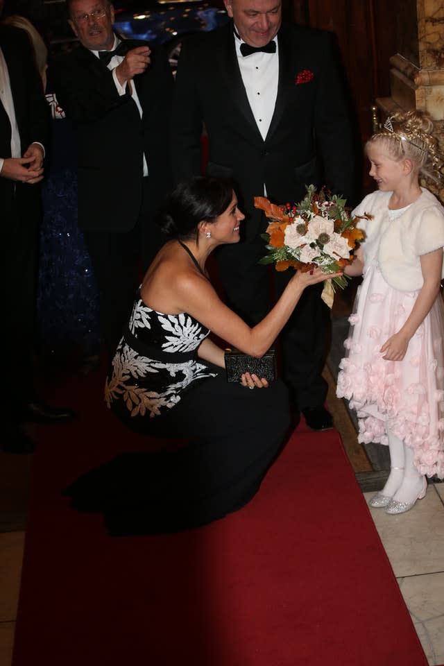 The Duchess of Sussex is presented with a bouquet