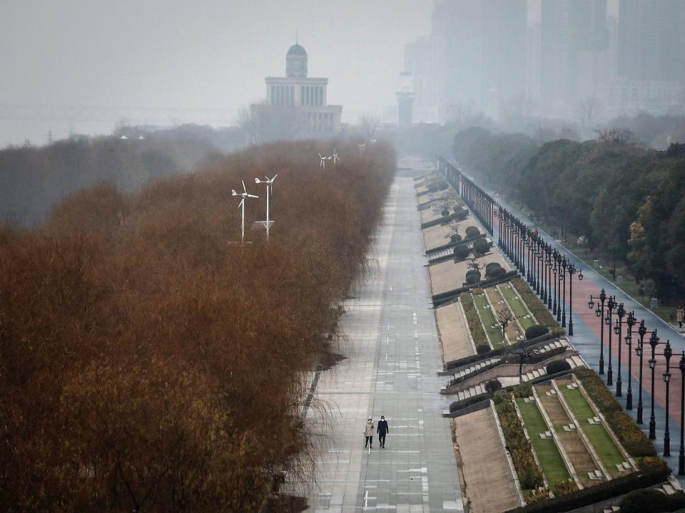 Two residents walk in an empty Jiangtan park on January 27, 2020 in Wuhan, China. As the death toll from the coronavirus reaches 80 in China with over 2700 confirmed cases, the city remains on lockdown for a fourth day.