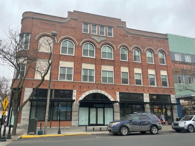 Kaylee and Maddie bought food at popular Grub Truck on their home on Saturday night, which was parked outside this red brick building on Main Street in downtown Moscow (Sheila Flynn)