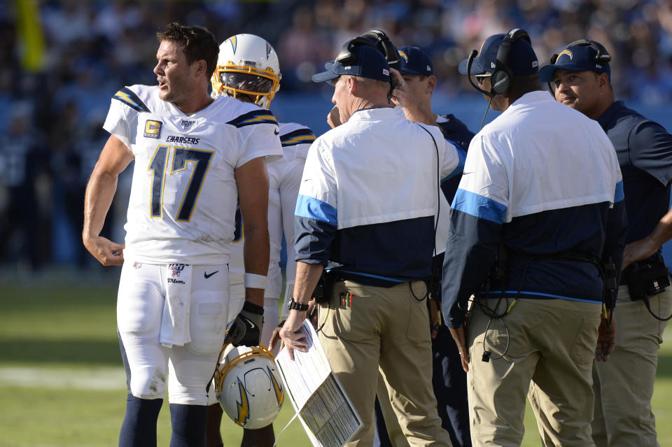 Los Angeles Chargers quarterback Philip Rivers (17) talks with coaches in the first half of an NFL football game against the Tennessee Titans Sunday, Oct. 20, 2019, in Nashville, Tenn. (AP Photo/Mark Zaleski)