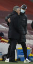 Everton's manager Carlo Ancelotti, left, speaks to Liverpool's manager Jurgen Klopp just prior to the start of the English Premier League soccer match between Liverpool and Everton at Anfield in Liverpool, England, Saturday, Feb. 20, 2021. (Paul Ellis / Pool via AP)