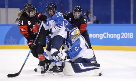 Ice Hockey – Pyeongchang 2018 Winter Olympics – Women Preliminary Round Match - Canada v Finland - Kwandong Hockey Centre, Gangneung, South Korea – February 13, 2018 - Canada's Natalie Spooner and Jennifer Wakefield in action with Finland's Minnamari Tuominen and goalkeeper Noora Raty. REUTERS/David W Cerny