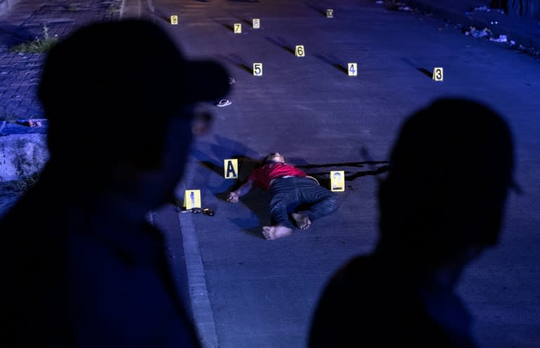 The body of an alleged drug dealer killed during a police anti-drug operation is seen on the ground in Manila on August 18, 2017