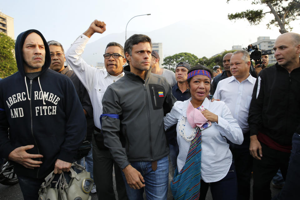 Opposition leader Leopoldo Lopez, center, is seen surrounded by supporters outside La Carlota air base in Caracas, Venezuela, Tuesday, April 30, 2019. Lopez, who had been under house arrest for leading an anti-government push in 2014, said he had been freed by soldiers and called for a military uprising. (Photo: Ariana Cubillos/AP)
