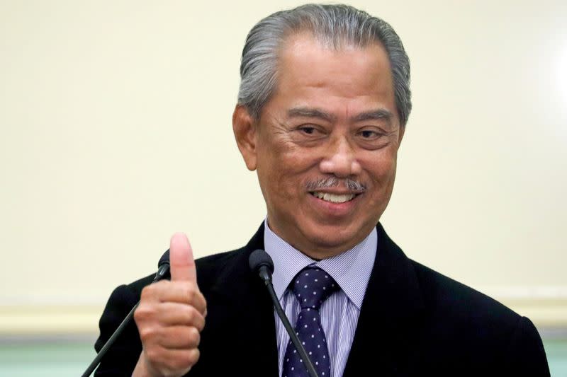 FILE PHOTO: Malaysia's Prime Minister Muhyiddin Yassin gestures after his cabinet announcement in Putrajaya