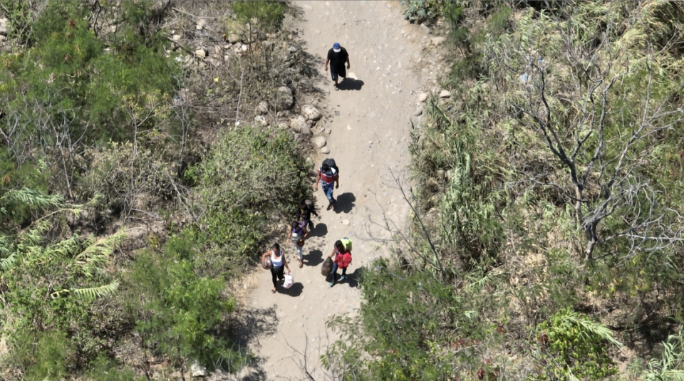 People cross the Venezuela-Colombia border through one of the numerous illegal trails known as ‘trochas’ that are often controlled by criminal groups. CNN