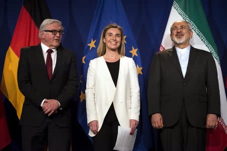 Iranian Foreign Minister Javad Zarif (R) waits to make a statement, next to German Foreign Minister Frank Walter Steinmeier (L) and European Union High Representative for Foreign Affairs and Security Policy Federica Mogherini, following nuclear talks at the Swiss Federal Institute of Technology in Lausanne (Ecole Polytechnique Federale De Lausanne) in Lausanne April 2, 2015. REUTERS/Brendan Smialowski/Pool