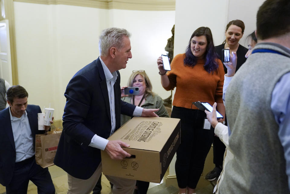 House Speaker Kevin McCarthy of Calif., carries food for members of the press covering debt limit negotiations, Saturday, May 27, 2023, on Capitol Hill in Washington. (AP Photo/Patrick Semansky)