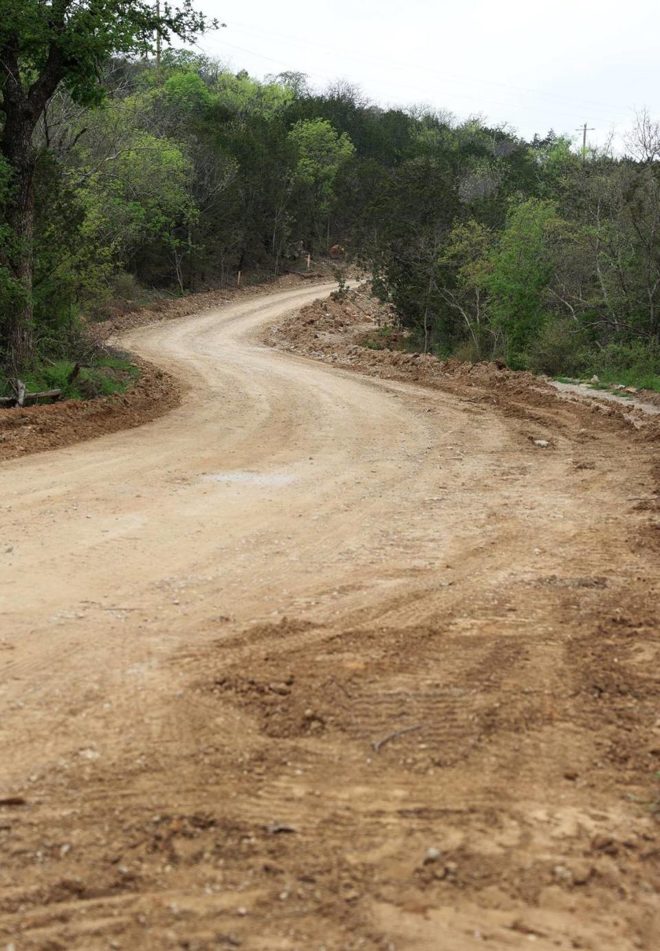 A cut road that is in the process of being grades winds through Palo Pinto Mountains State Park on Monday, April 1, 2024. Much of the infrastructure, such utilities and trails, are in place for as work continues to finish construction of the metroplex’s newest state park.