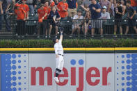 Detroit Tigers right fielder Zach McKinstry reaches but is unable to catch the solo home run hit by Arizona Diamondbacks' Corbin Carroll during the first inning of a baseball game, Friday, June 9, 2023, in Detroit. (AP Photo/Carlos Osorio)