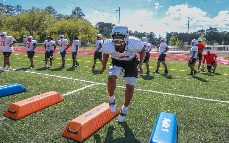 Jenkins High's Tavion Gadson runs drills  during spring practice.