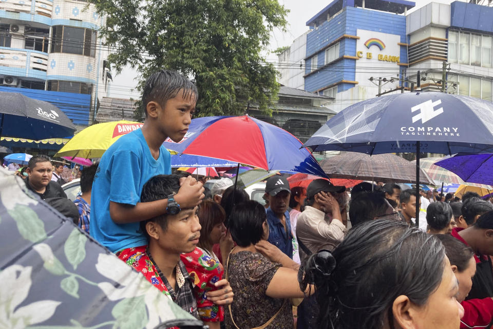 People wait for their family members and relatives outside Insein Prison Thursday, Nov. 17, 2022, in Yangon, Myanmar. The country's military-controlled government announced Thursday it was releasing and deporting an Australian academic, a Japanese filmmaker, an ex-British diplomat and an American as part of a broad prisoner amnesty to mark the country’s National Victory Day. (AP Photo)