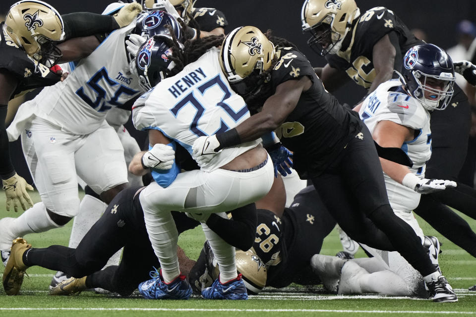 New Orleans Saints linebacker Demario Davis, right, tackles Tennessee Titans running back Derrick Henry (22) in the first half of an NFL football game in New Orleans, Sunday, Sept. 10, 2023. (AP Photo/Gerald Herbert)