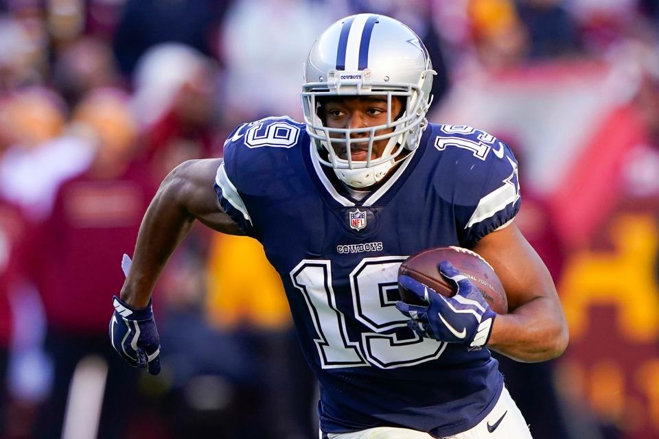 Dallas Cowboys wide receiver Amari Cooper (19) runs with the ball during the first half of an NFL football game against the Washington Football Team, on Dec. 12, 2021, in Landover, Md. (AP Photo/Alex Brandon, File)