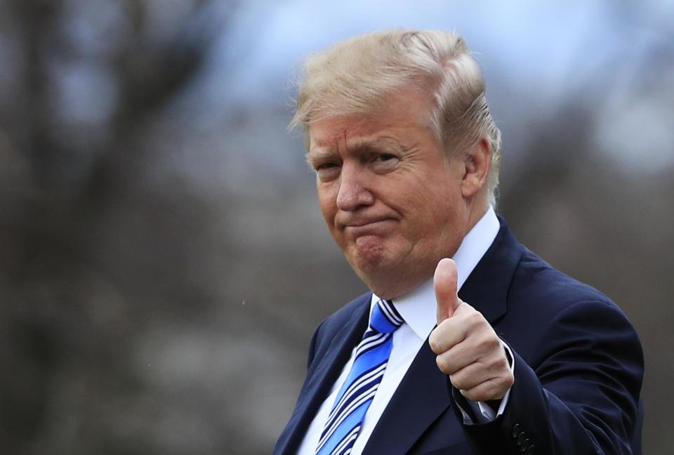 Donald Trump gestures to the media as he leaves the White House: AP