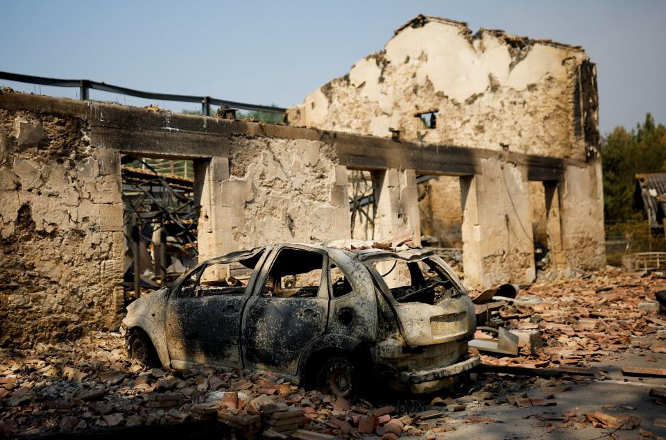 A view of a house and a car destroyed by fire in Belin-Beliet, as wildfires continue to spread in the Gironde region of southwestern France (REUTERS)