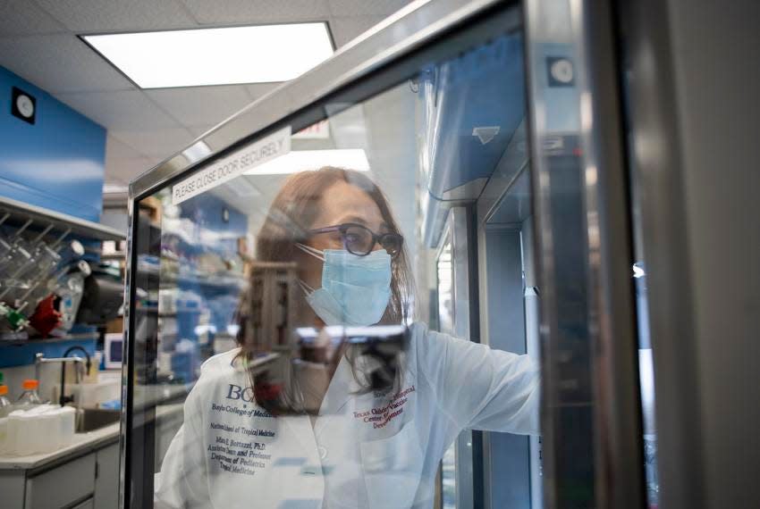 Maria Bottazzi replaces vials of the vaccine into a freezer at the Tropical Medicine Lab at Texas Children’s Hospital Center for Vaccine Development in Houston.