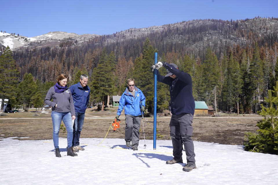 FILE - Sean de Guzman, manager of snow surveys and water supply for the California Department of Water Resources, plunges the snowpack measuring tube into a small patch of snow on the snow course as he conducts the fourth snow survey of the season at Phillips Station near Echo Summit, Calif., on Friday, April 1, 2022. California's water usage jumped nearly 19% in March during one of the driest months on record, state officials announced, Tuesday, May 10, 2022. The statewide snowpack was at 27% of its historic average as of April 1. (AP Photo/Rich Pedroncelli File)