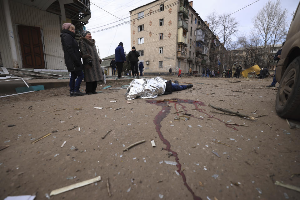 Nina Kovalenko, 66, cries over the body of her son Mykhailo Kovalenko, 34, who was killed by a Russian attack in Kostiantynivka, Ukraine, Saturday, Jan. 28, 2023. (AP Photo/Andriy Dubchak)