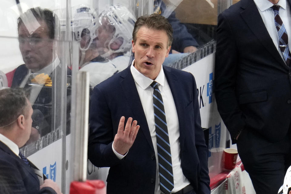 FILE - Los Angeles Kings interim head coach Jim Hiller, center, gives instructions during the third period of an NHL hockey game against the Pittsburgh Penguins in Pittsburgh, Sunday, Feb. 18, 2024. Jim Hiller will stay as Los Angeles Kings head coach after having the interim tag removed Wednesday, May 22, by vice president and general manager Rob Blake. (AP Photo/Gene J. Puskar, File)