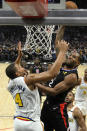 Los Angeles Clippers forward Kawhi Leonard, right, goes up for a dunk as Golden State Warriors forward Omari Spellman defends during the second half of an NBA basketball game Friday, Jan. 10, 2020, in Los Angeles. The Clippers won 109-100. (AP Photo/Mark J. Terrill)