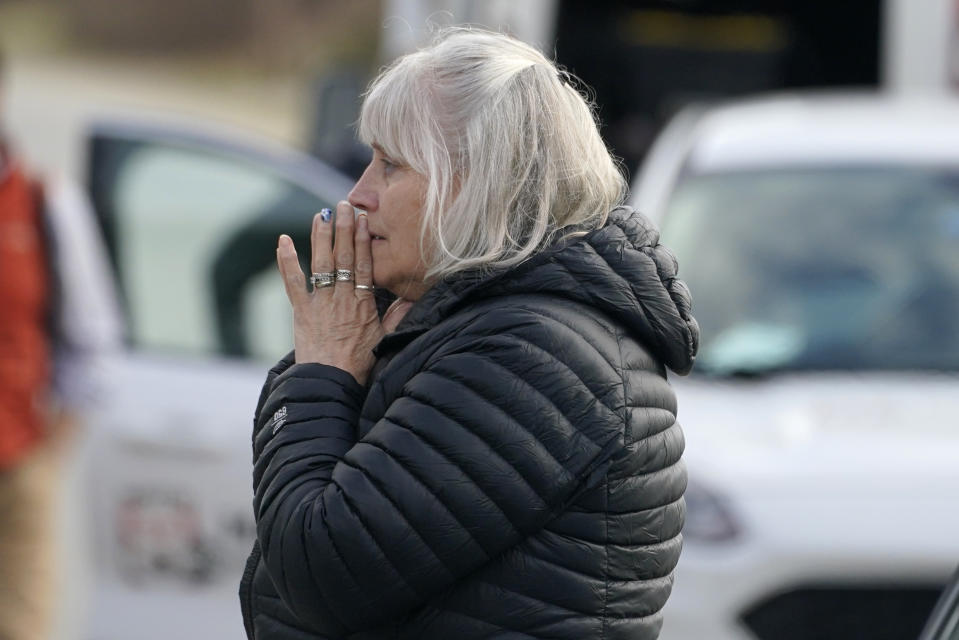 FILE - A woman reacts at the scene of a mass shooting, Tuesday, April 18, 2023, in Bowdoin, Maine. A 32-year-old man confessed to fatally shooting four people, including his parents, at a home. From there he fled and fired shots at moving vehicles on a highway. Several vehicles were hit by gunfire but the three people injured were a family all in the same car. (AP Photo/Robert F. Bukaty, File)