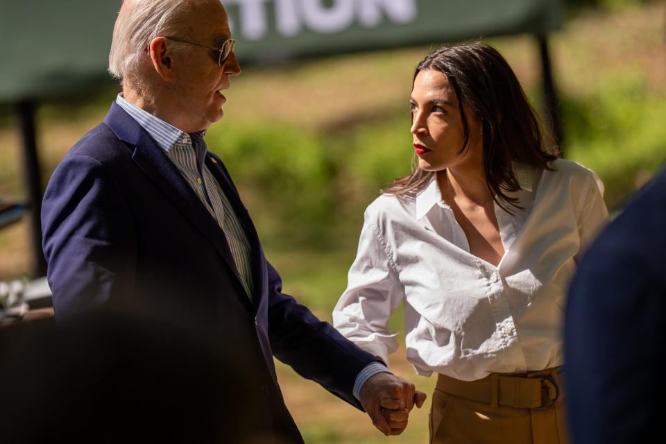 President Joe Biden speaks with Rep. Alexandria Ocasio-Cortez, D-N.Y., following an Earth Day speech in Virginia.