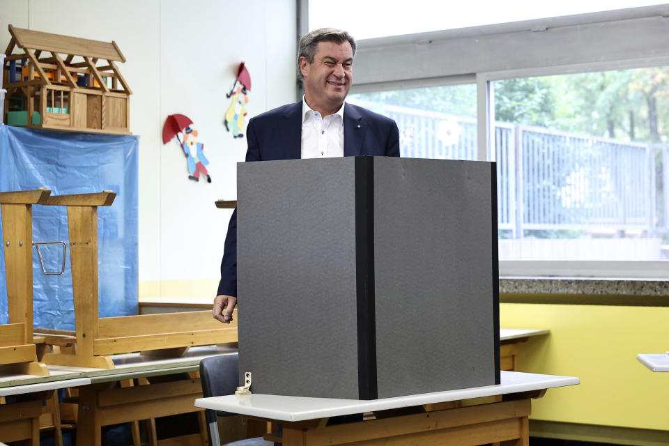 Bavaria region governor Markus Soeder casts his vote at the Theodor Billroth School, in Nuremberg, Germany, Sunday, Oct. 8, 2023. Two German states hold elections on Sunday at the halfway mark of Chancellor Olaf Scholz's unpopular national government, with polls showing the center-right opposition well ahead and Germany's interior minister facing an uphill struggle in a bid to become governor of her home region. (Daniel Karmann/dpa via AP)