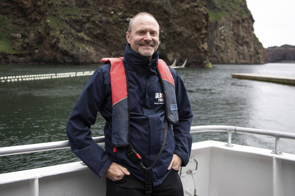 Andy Bool, head of Sea Life Trust in Klettsvik Bay, Heimaey Island, Iceland, Tuesday June 18, 2019 where two Beluga Whales Little White and Little Grey are being rehomed in an open-water sanctuary after years of captivity in Shanghai, China. In a world first by the Sea Life Trust, the whales have been transported 6,000 miles by air, land and sea to Iceland where they will be cared for in a special tank for around a month before being permanently moved to their new, open-water home. (Aaron Chown/PA via AP)