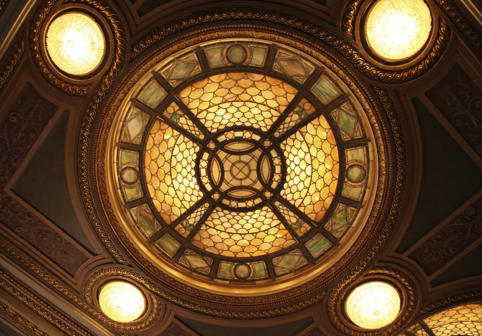 This Oct. 29, 2019 photo shows a close-up of one of Louis Comfort Tiffany’s stained glass and bronze lights in the lobby of the Hudson Theatre on West 44th Street in New York. A newly launched tour of the Hudson Theatre offers a rare chance to wander around the interior of Broadway’s oldest theater and hear some of the fascinating stories that have happened in its 116 years. (AP Photo/Mark Kennedy)