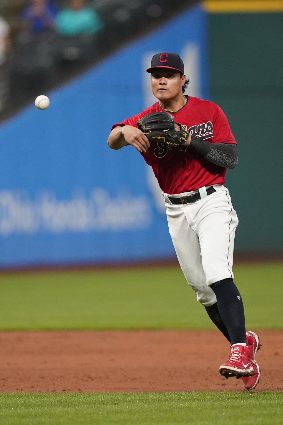 Cleveland Indians' Yu Chang throws out Kansas City Royals' Hunter Dozier in the fifth inning of a baseball game, Tuesday, Sept. 21, 2021, in Cleveland. The Indians won 4-1. (AP Photo/Tony Dejak)