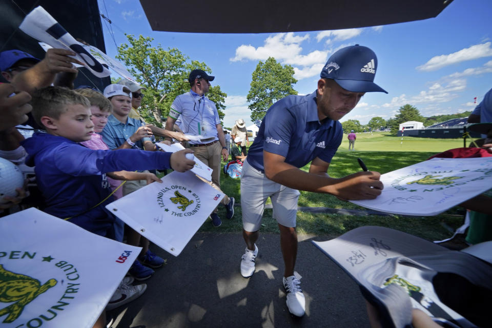 Xander Schauffele gives autographs at The Country Club, Monday, June 13, 2022, in Brookline, Mass., following a practice round ahead of the U.S. Open golf tournament. (AP Photo/Robert F. Bukaty)