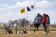 University of the Southwest golf players, from left, Phillip Lopez, Jonny Flores and Halie Cruz visit the site of a memorial, Thursday, March 17, 2022 at the Rockwind Community Links in Hobbs, N.M., erected for the victims of the USW golf team's vehicle crash. (Odessa American/Odessa American via AP)