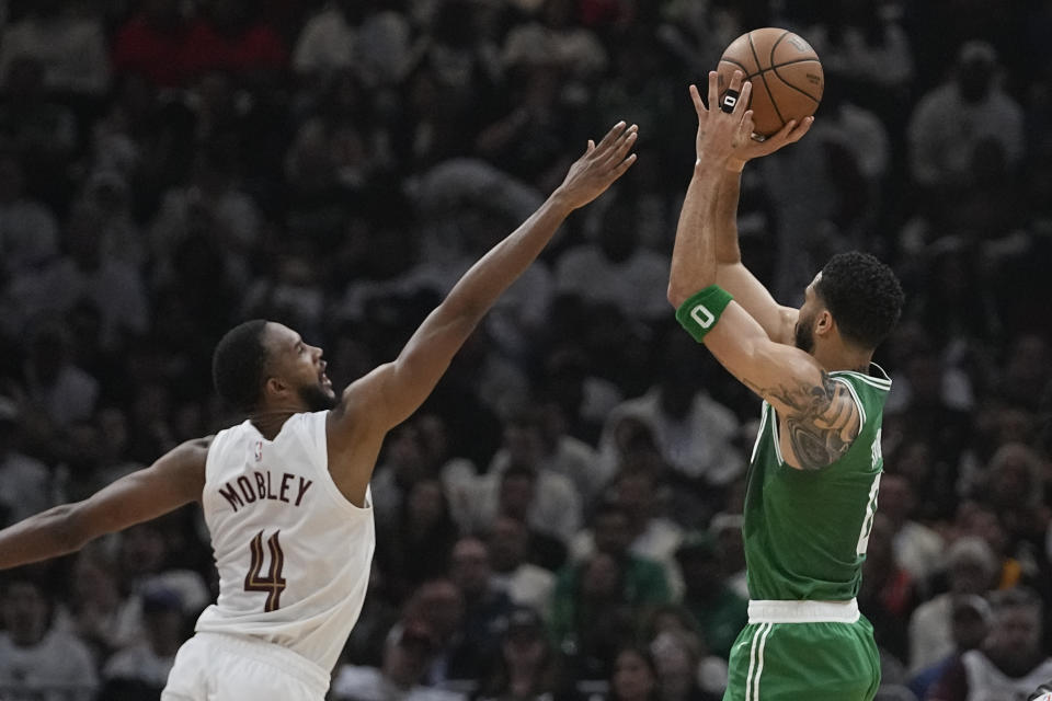 Boston Celtics forward Jayson Tatum (0) shoots over Cleveland Cavaliers forward Evan Mobley (4) during the first half of Game 3 of an NBA basketball second-round playoff series Saturday, May 11, 2024, in Cleveland. (AP Photo/Sue Ogrocki)