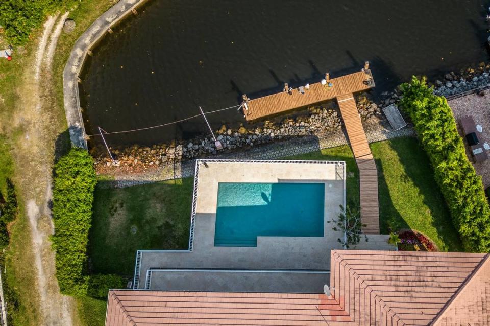 View of the Coral Gables home at 11025 Tanya St. where police say a boat matching the description of the vessel that struck and killed Ella Adler near Nixon Beach Sandbar on Saturday was located and seized from the deck in the home back canal, in Coral gables, on Tuesday, May 14, 2024.