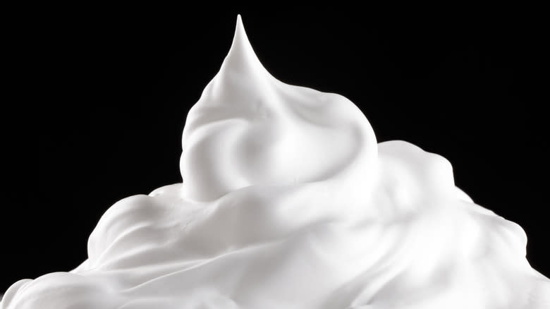 whipped cream on black background