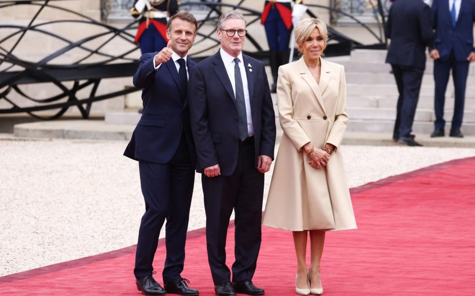 Emmanuel Macron, Sir Keir Starmer and Brigitte Macron at the Elysee in Paris, France, for an Olympic Games reception