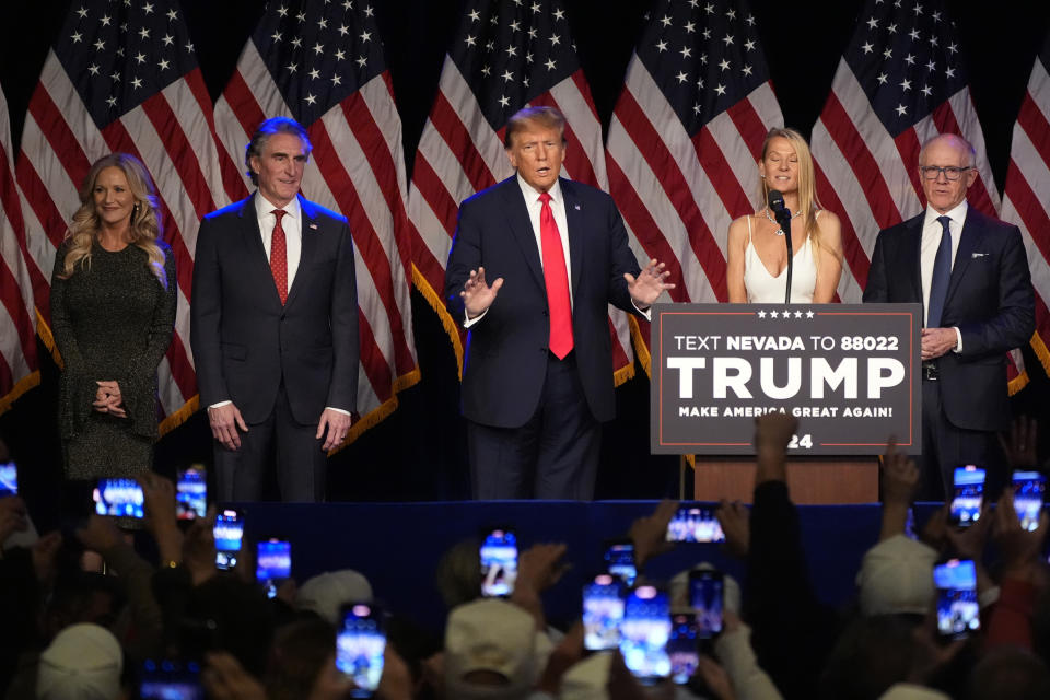 Republican presidential candidate former President Donald Trump arrives to speak at a caucus night rally in Las Vegas, Thursday, Feb. 8, 2024. At left are North Dakota Gov. Doug Burgum and his wife Kathryn and at right are Woody Johnson and his wife Suzanne. (AP Photo/Mark J. Terrill)