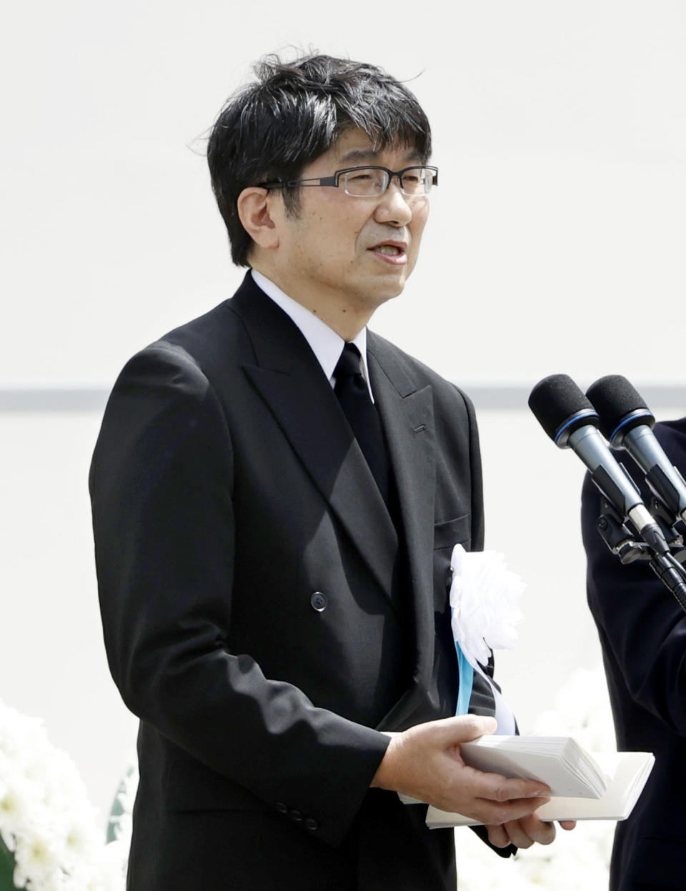 Mayor Tomihisa Taue delivers a speech during a ceremony to mark the 75th anniversary of the U.S. atomic bombing at the Peace Park in Nagasaki, southern Japan Sunday, Aug. 9, 2020. At the event at Nagasaki Peace Park, scaled down because of the coronavirus pandemic, Mayor Taue read a peace declaration in which he raised concern that nuclear states had in recent years retreated from disarmament efforts. (Kyodo News via AP)