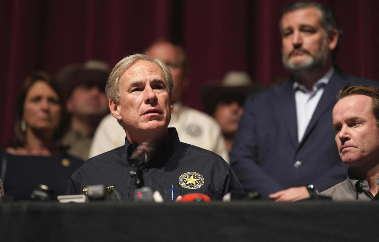 Texas Gov. Greg Abbott holds a press conference in Uvalde, Texas, on May 25, the day after the massacre at Robb Elementary. Sen. Ted Cruz stands in the background at right. 