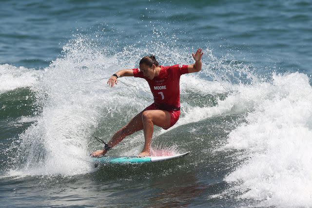 <p>Ryan Pierse/Getty </p> Carissa Moore of Team United States surfs during the during the Women's Round 1 heat on day two of the Tokyo 2020 Olympic Games on July 25, 2021 in Ichinomiya, Chiba, Japan.