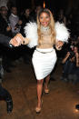 Over the years, Lil' Kim has committed many crimes against fashion, and Wednesday was no exception for the pint-size rapper as she arrived at The Blonds Fall 2012 fashion show in NYC wearing another wacky ensemble.Not only did it look as if a Muppet had been skinned in order to make the shrug covering her bedazzled nude shirt, but her belt was way too big for her tiny waist. Still, we doubt that Lil' Kim cares what we think. "Whether I make the best-dressed list, or the worst-dressed list, I'm still fly and all of my clothes are still very fashionable," she has said. (2/15/2012)