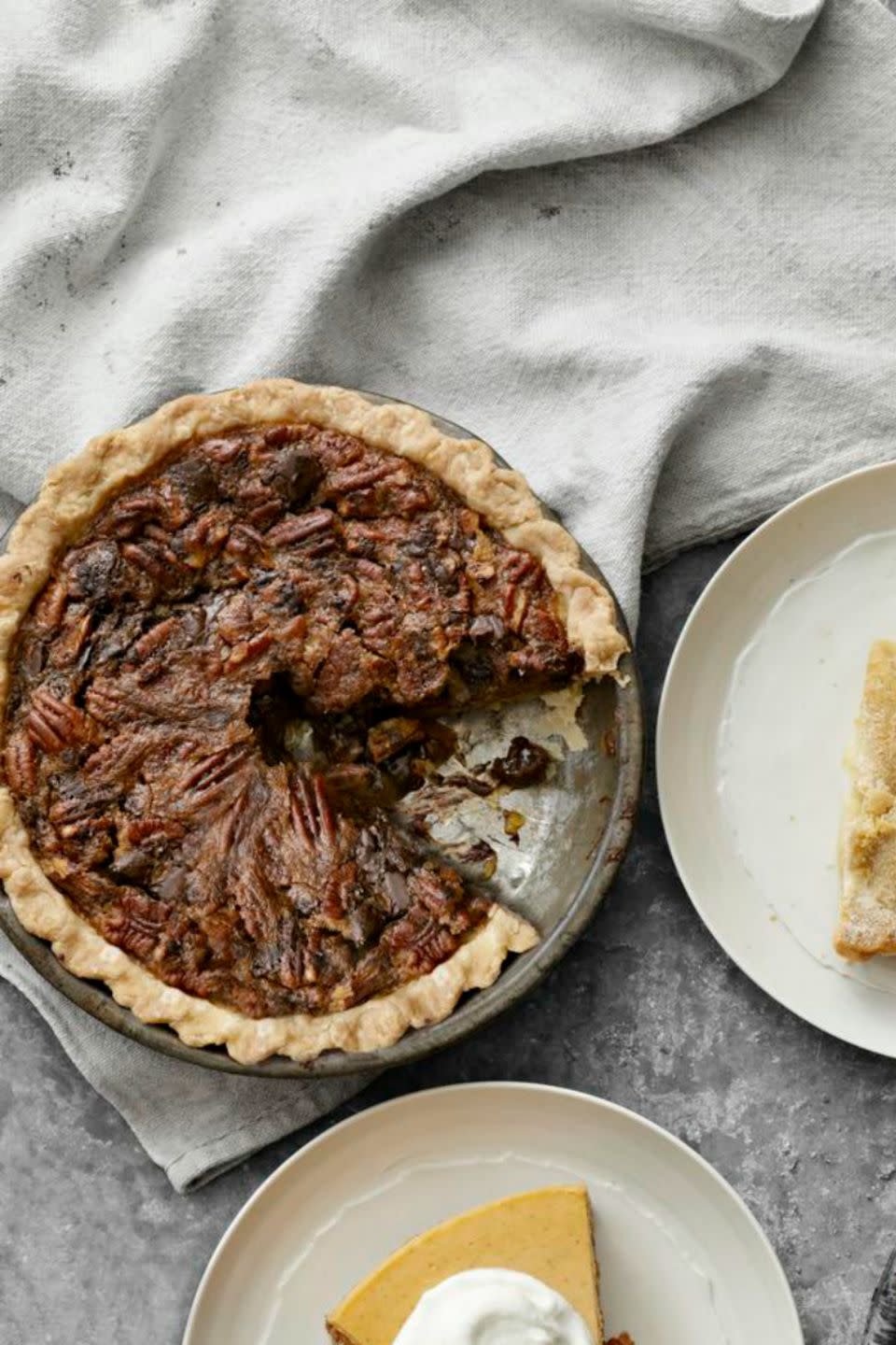 <p>The earthiness of bittersweet chocolate and rich pecans melds with layers of sweet filling for a deep flavor everyone will linger around the table to savor.</p><p><strong><a rel="nofollow noopener" href="https://www.womansday.com/food-recipes/food-drinks/recipes/a39164/chocolate-chunk-pecan-pie-recipe-clv1112/" target="_blank" data-ylk="slk:Get the recipe.;elm:context_link;itc:0;sec:content-canvas" class="link ">Get the recipe.</a></strong></p>