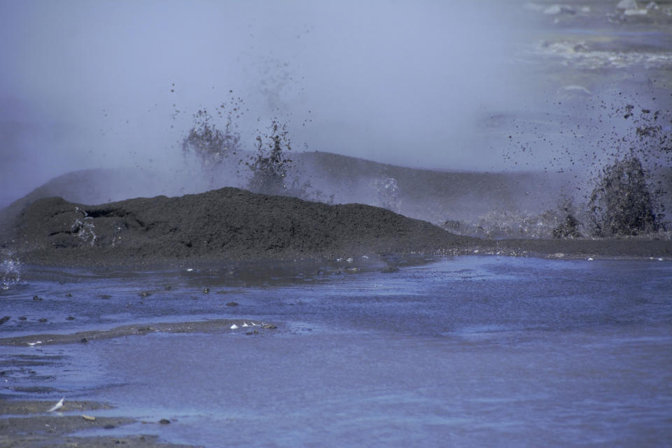 This August 2019 photo released by the National Oceanic and Atmospheric Administration Fisheries (NOAA) shows mud shooting upward from the openings near a volcano on Bogoslof Island, Alaska. Alaska's northern fur seals are thriving on an island that's the tip of an active undersea volcano. Numbers of fur seals continue to grow on tiny Bogoslof Island despite hot mud, steam and sulfurous gases spitting from vents on the volcano. (Maggie Mooney-Seus/NOAA Fisheries via AP)